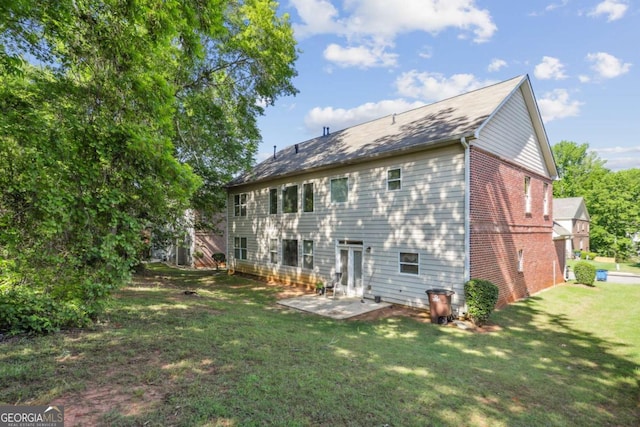 1520 Ethans Way, Mcdonough, GA 30252 - rear view of property with a yard, brick siding, and a patio