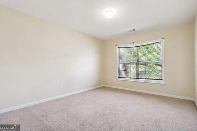 1520 Ethans Way, Mcdonough, GA 30252 - spare room featuring baseboards and carpet