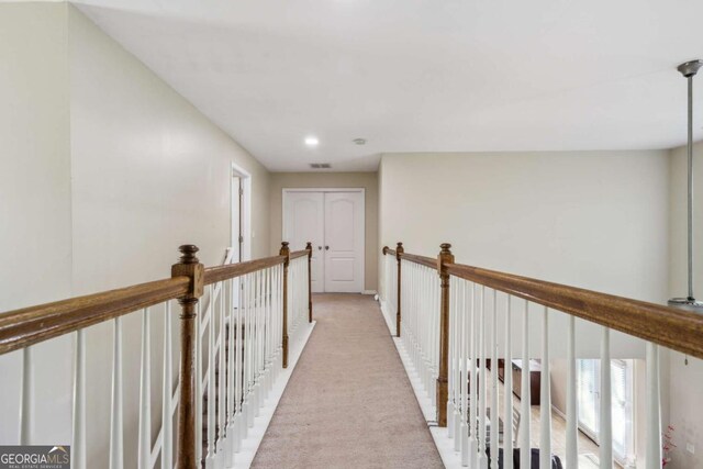 1520 Ethans Way, Mcdonough, GA 30252 - corridor with light carpet, an upstairs landing, and baseboards