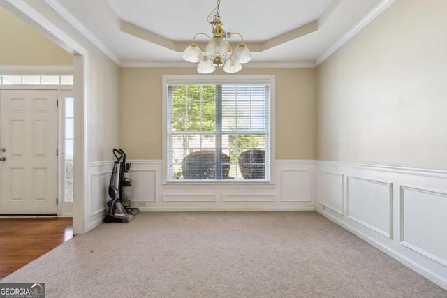 1520 Ethans Way, Mcdonough, GA 30252 - entryway featuring a raised ceiling, carpet floors, a chandelier, wainscoting, and ornamental molding