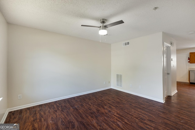 unfurnished room with dark wood-type flooring, a ceiling fan, a textured ceiling, baseboards, and fire sprinkler in ceiling