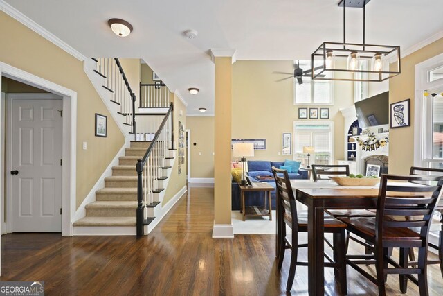 6317 Benbrooke Overlook NW, Acworth, GA 30101 - dining area featuring ceiling fan, dark wood-style flooring, stairs, and crown molding