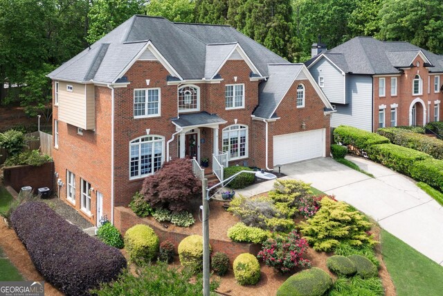 6317 Benbrooke Overlook NW, Acworth, GA 30101 - colonial inspired home featuring an attached garage, brick siding, and concrete driveway