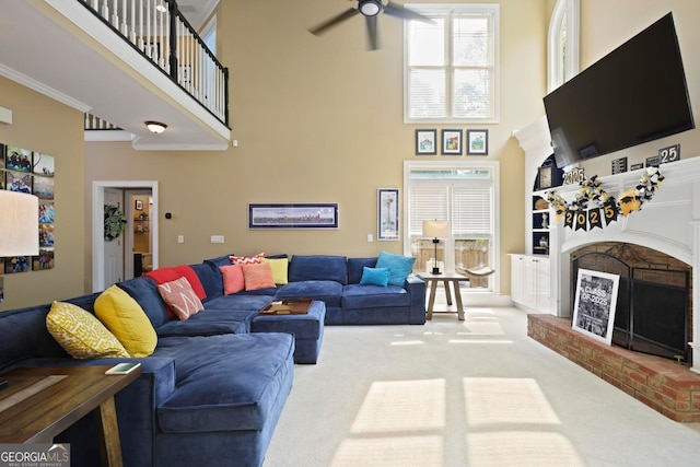 6317 Benbrooke Overlook NW, Acworth, GA 30101 - carpeted living room featuring a brick fireplace, a towering ceiling, ceiling fan, healthy amount of natural light, and crown molding