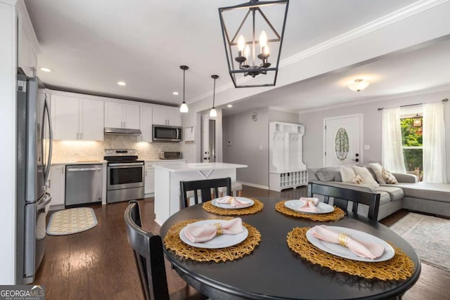 3890 Cherrydale Ln SE, Smyrna, GA 30082 - dining space with crown molding, a chandelier, dark wood-style flooring, and recessed lighting