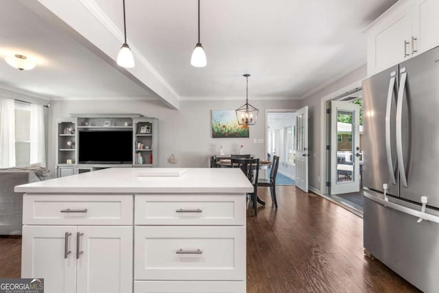 3890 Cherrydale Ln SE, Smyrna, GA 30082 - kitchen with freestanding refrigerator, dark wood-style flooring, crown molding, open floor plan, and light countertops