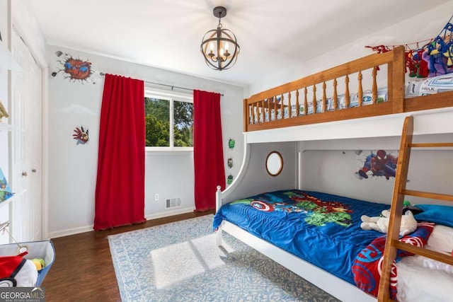 3890 Cherrydale Ln SE, Smyrna, GA 30082 - bedroom featuring wood finished floors, a chandelier, and baseboards