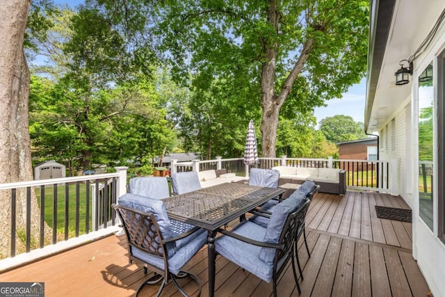 3890 Cherrydale Ln SE, Smyrna, GA 30082 - deck featuring outdoor dining space, outdoor lounge area, a shed, an outbuilding, and view of scattered trees