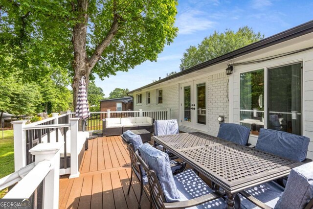 3890 Cherrydale Ln SE, Smyrna, GA 30082 - wooden deck featuring outdoor dining space, outdoor lounge area, and french doors