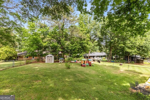 3890 Cherrydale Ln SE, Smyrna, GA 30082 - view of yard featuring a storage unit, view of scattered trees, and an outdoor structure