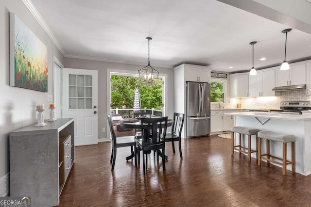 3890 Cherrydale Ln SE, Smyrna, GA 30082 - dining space with plenty of natural light, dark wood-style flooring, crown molding, recessed lighting, and baseboards