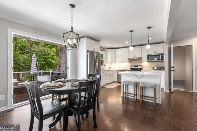 3890 Cherrydale Ln SE, Smyrna, GA 30082 - dining space featuring dark wood-type flooring, ornamental molding, recessed lighting, a chandelier, and baseboards