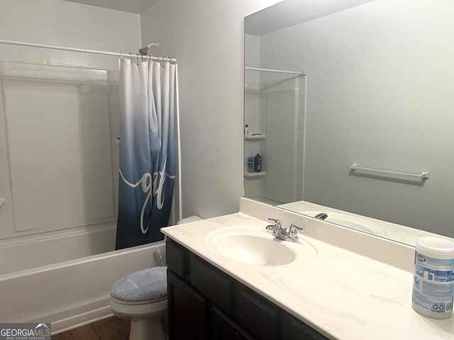 bathroom with toilet, shower / tub combo, vanity, and wood finished floors