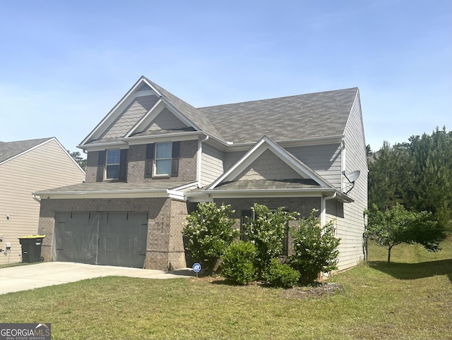 craftsman house with concrete driveway, a front yard, an attached garage, and brick siding