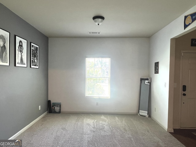 spare room with carpet flooring and baseboards