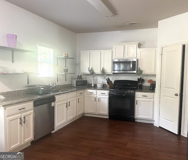 kitchen featuring stainless steel appliances, open shelves, dark wood-style flooring, and white cabinets