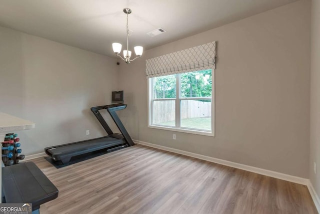 592 Eagles Nest Cir, Auburn, GA 30011 - exercise room featuring wood finished floors, a chandelier, and baseboards