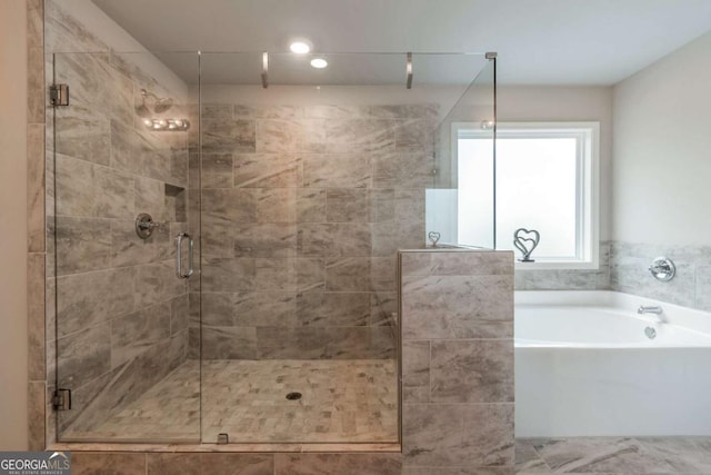 592 Eagles Nest Cir, Auburn, GA 30011 - bathroom featuring a bath and a stall shower