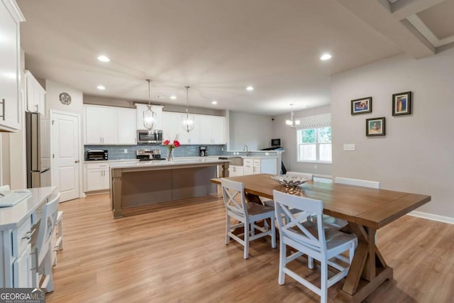 592 Eagles Nest Cir, Auburn, GA 30011 - dining area featuring recessed lighting, a chandelier, light wood-style flooring, and baseboards