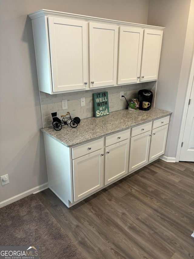 457 Panhandle Pl, Hampton, GA 30228 - kitchen featuring dark wood-style flooring, baseboards, white cabinets, backsplash, and light stone counters