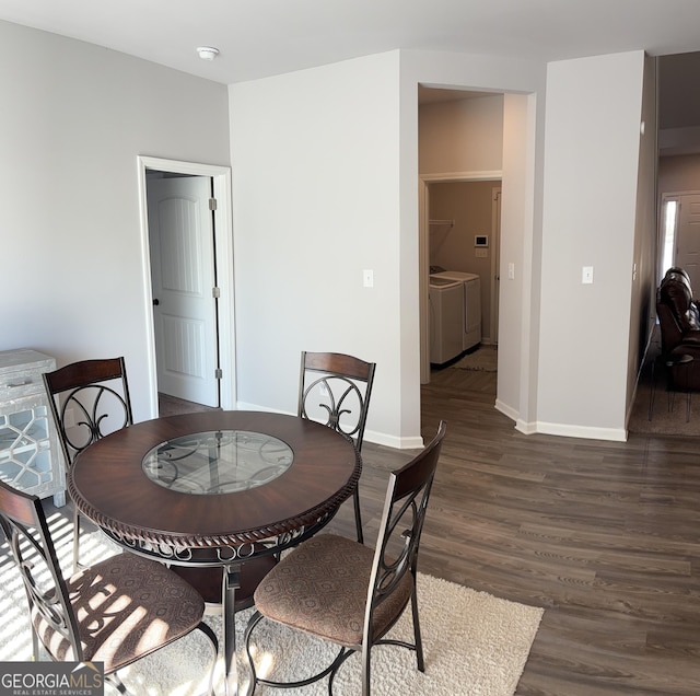 457 Panhandle Pl, Hampton, GA 30228 - dining space featuring washer and clothes dryer, dark wood-style floors, and baseboards