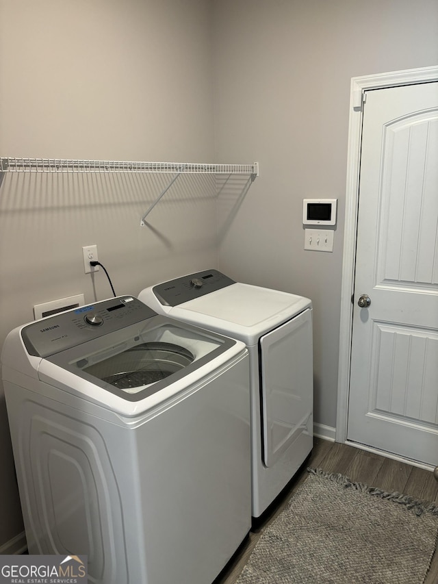 457 Panhandle Pl, Hampton, GA 30228 - clothes washing area with separate washer and dryer, wood finished floors, and baseboards