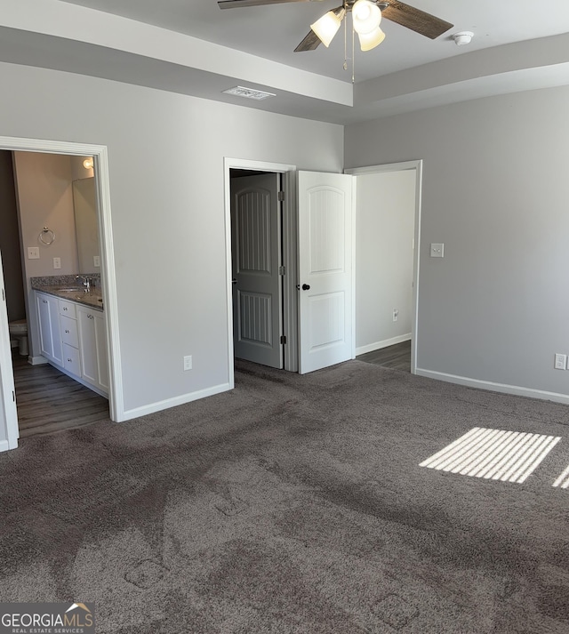 457 Panhandle Pl, Hampton, GA 30228 - unfurnished bedroom featuring dark colored carpet, baseboards, and connected bathroom