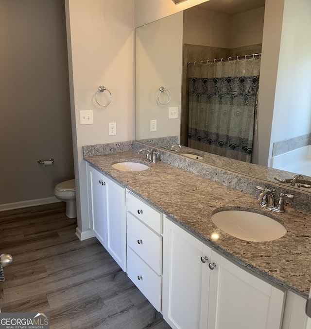 457 Panhandle Pl, Hampton, GA 30228 - full bath featuring toilet, wood finished floors, double vanity, and curtained shower