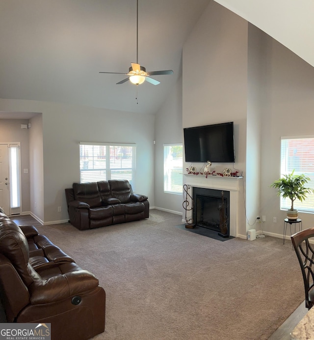 457 Panhandle Pl, Hampton, GA 30228 - carpeted living room featuring high vaulted ceiling, a ceiling fan, baseboards, and a fireplace with flush hearth