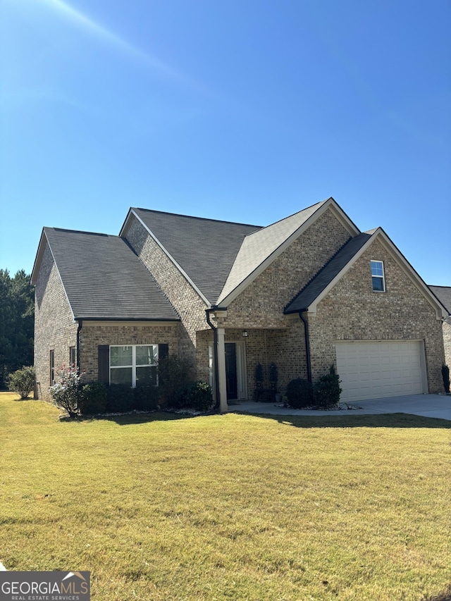 457 Panhandle Pl, Hampton, GA 30228 - view of front of home featuring a front yard, a garage, brick siding, and driveway