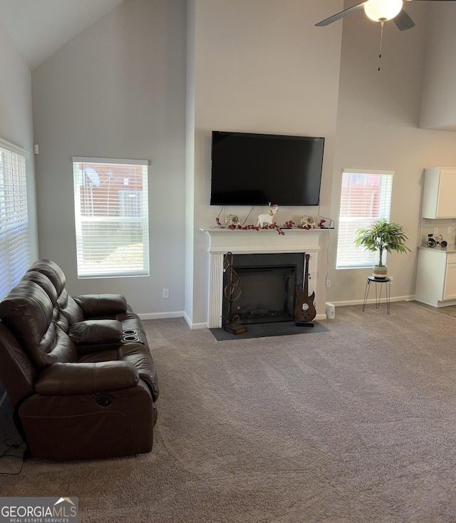 457 Panhandle Pl, Hampton, GA 30228 - living room with high vaulted ceiling, ceiling fan, carpet flooring, baseboards, and a fireplace with flush hearth