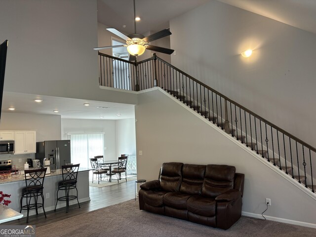 457 Panhandle Pl, Hampton, GA 30228 - living room featuring a towering ceiling, a ceiling fan, stairway, recessed lighting, and dark wood-type flooring
