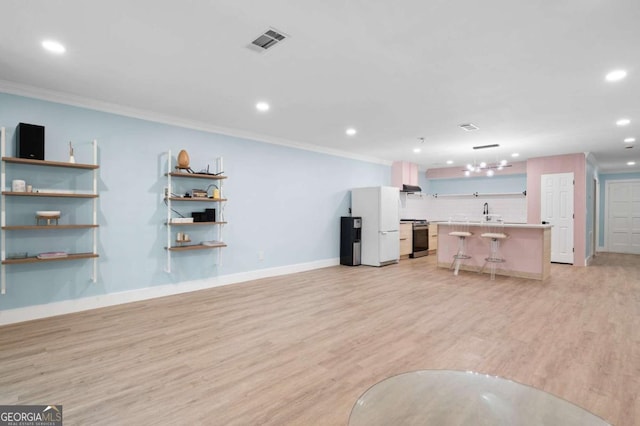 845 Lake Hollow Blvd SW, Marietta, GA 30064 - unfurnished living room featuring ornamental molding, recessed lighting, light wood-style floors, and baseboards