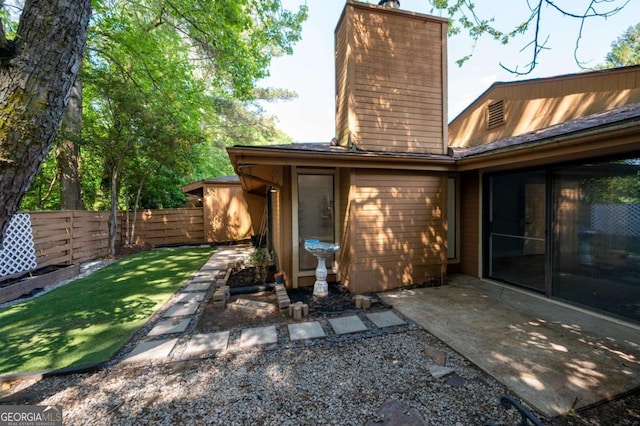 845 Lake Hollow Blvd SW, Marietta, GA 30064 - rear view of property featuring a chimney and a patio