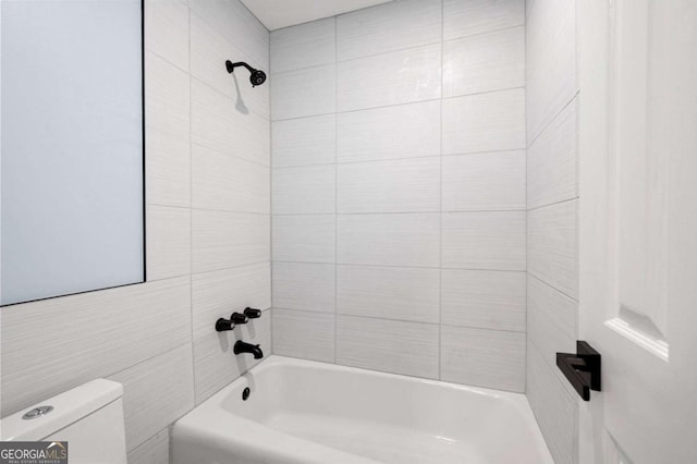 845 Lake Hollow Blvd SW, Marietta, GA 30064 - bathroom featuring toilet, bathtub / shower combination, and tile walls