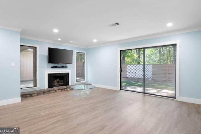 845 Lake Hollow Blvd SW, Marietta, GA 30064 - unfurnished living room with wood finished floors, baseboards, crown molding, recessed lighting, and a fireplace with raised hearth