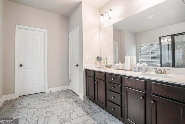 3415 Linstead Ct, Loganville, GA 30052 - full bathroom featuring marble look tile flooring, baseboards, double vanity, and a shower with shower door
