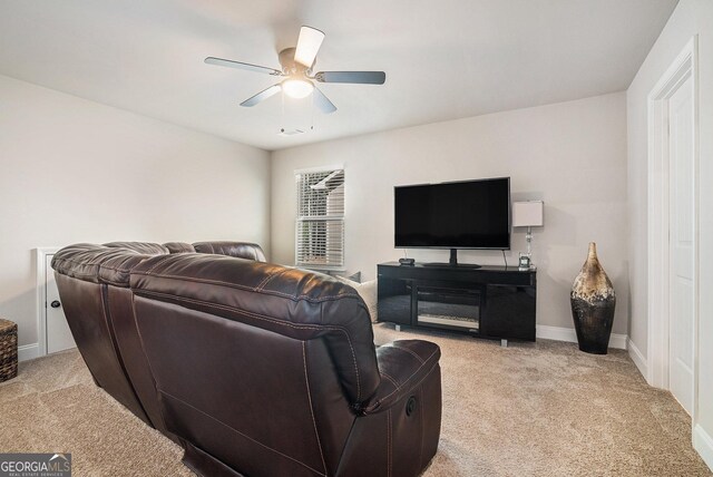 3415 Linstead Ct, Loganville, GA 30052 - living area with light carpet, a ceiling fan, and baseboards
