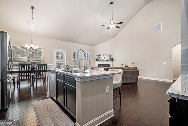 3415 Linstead Ct, Loganville, GA 30052 - kitchen featuring a sink, appliances with stainless steel finishes, ceiling fan, open floor plan, and dark cabinetry