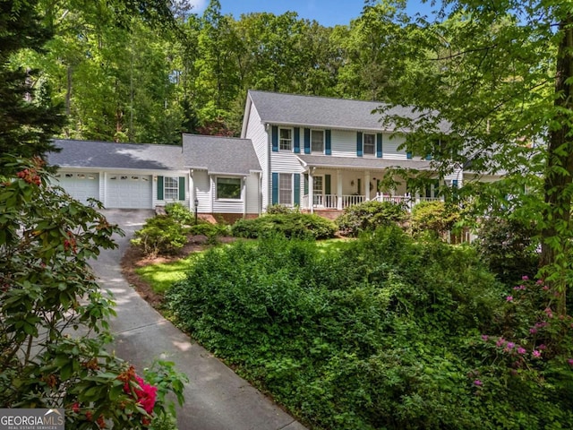 357 Breeze Hill Ln, Canton, GA 30114 - colonial house featuring an attached garage, asphalt driveway, and a porch