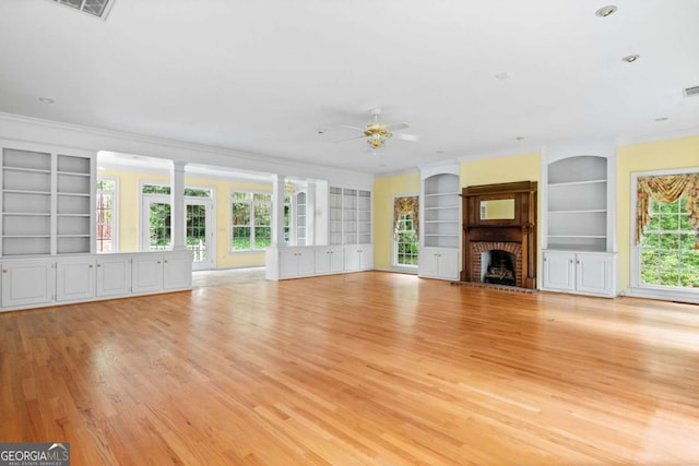 357 Breeze Hill Ln, Canton, GA 30114 - unfurnished living room with built in shelves, ornamental molding, a ceiling fan, light wood-style floors, and a brick fireplace