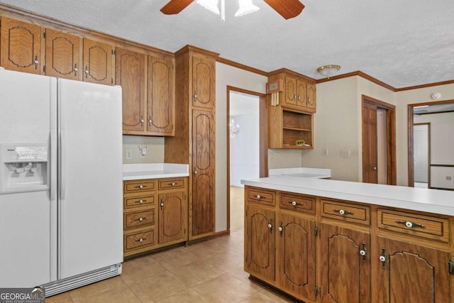 357 Breeze Hill Ln, Canton, GA 30114 - kitchen with white fridge with ice dispenser, a ceiling fan, a textured ceiling, brown cabinetry, and crown molding