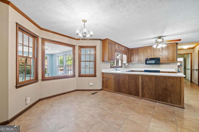 357 Breeze Hill Ln, Canton, GA 30114 - kitchen featuring black microwave, light countertops, ornamental molding, a chandelier, and brown cabinetry