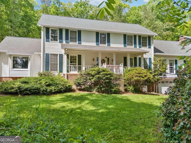357 Breeze Hill Ln, Canton, GA 30114 - colonial house featuring a front lawn, an attached garage, and a porch