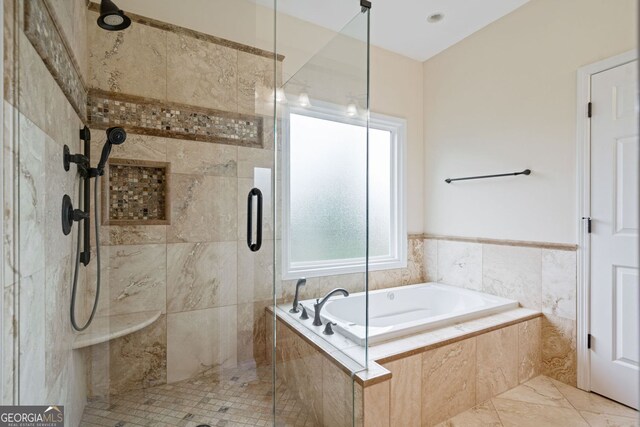 bathroom with a stall shower and a bath