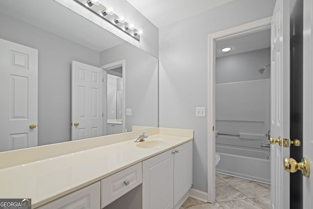 bathroom with vanity, toilet, shower / bathtub combination, and baseboards