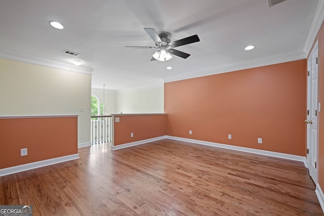 spare room with ornamental molding, a ceiling fan, wood finished floors, recessed lighting, and baseboards