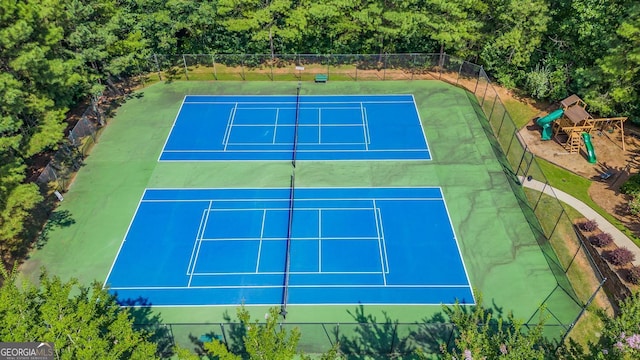 view of tennis court featuring fence