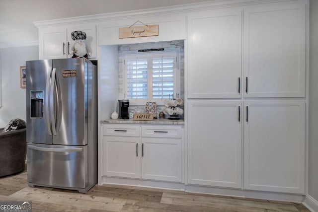118 Arrowhead Dr, Cartersville, GA 30120 - kitchen featuring stainless steel fridge with ice dispenser, white cabinetry, light wood-style floors, crown molding, and light stone counters
