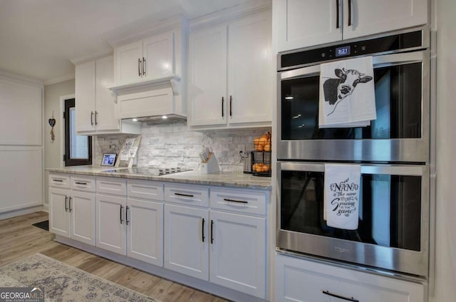118 Arrowhead Dr, Cartersville, GA 30120 - kitchen with double oven, black electric cooktop, white cabinetry, crown molding, and premium range hood
